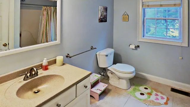 a bathroom with a sink toilet and a mirror