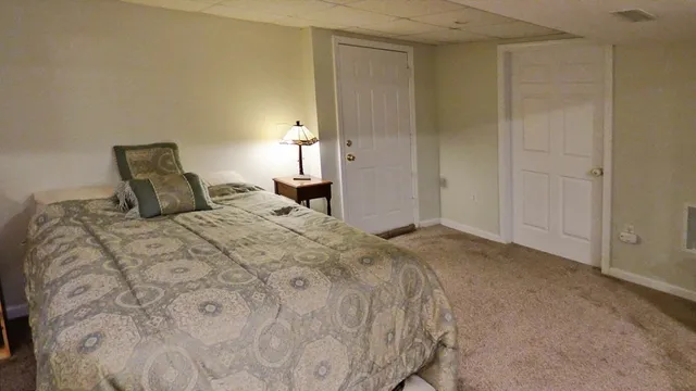 a bedroom with a bed and a lamp