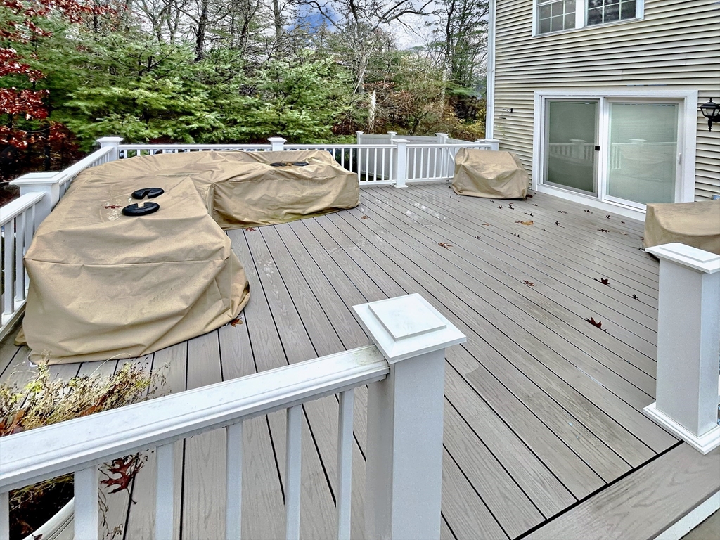 255 Holmes Street Hanson, MA 02341 - Photo 29 of 34 a balcony with wooden floor table and chairs