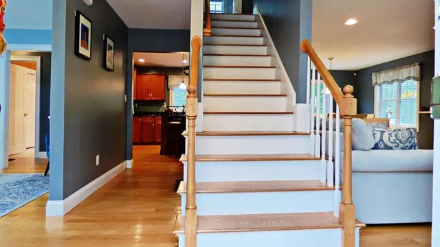 a view of entryway and hall with wooden floor