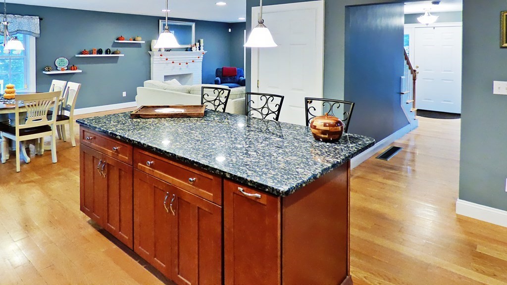 255 Holmes Street Hanson, MA 02341 - Photo 9 of 34 a kitchen with stainless steel appliances granite countertop a sink dishwasher stove and refrigerator with wooden floor
