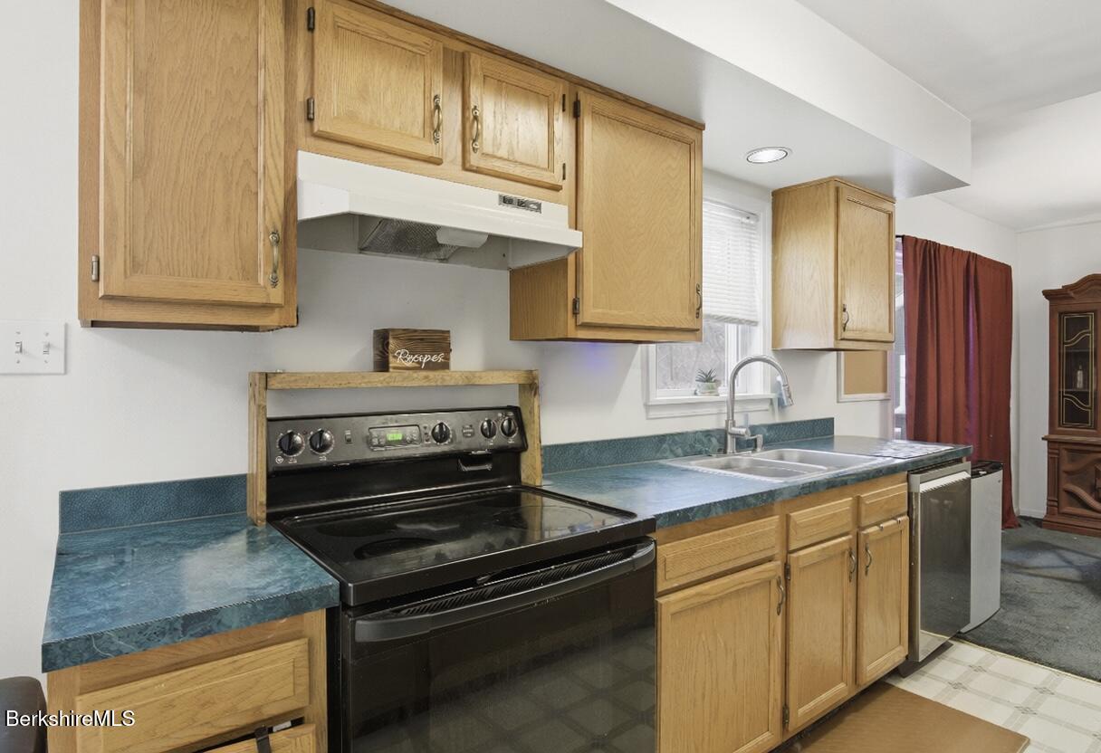 51 Notch Road North Adams, MA 01247 - Photo 11 of 21 a kitchen with granite countertop a sink stove and cabinets