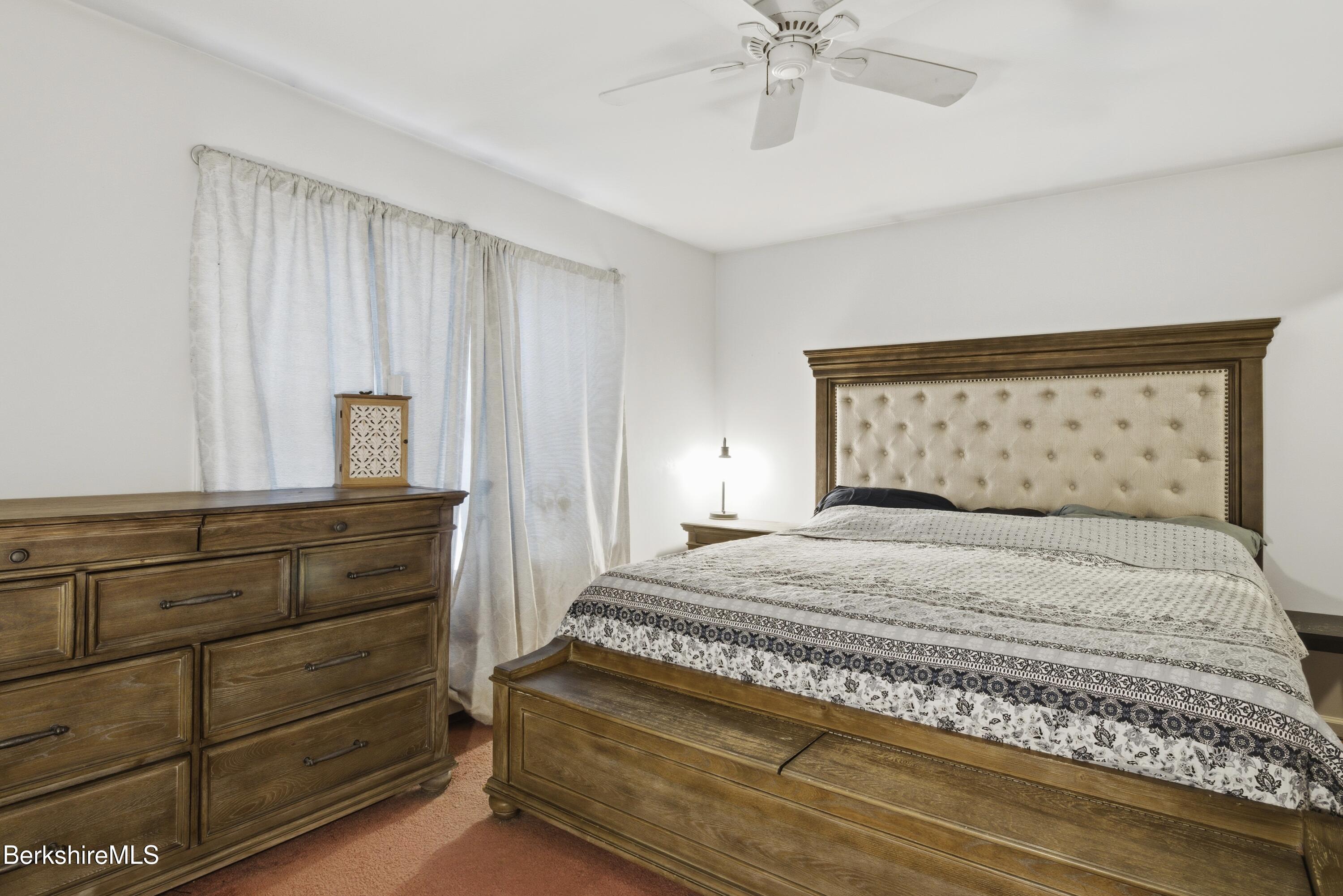 51 Notch Road North Adams, MA 01247 - Photo 14 of 21 a bedroom with a bed and a chandelier