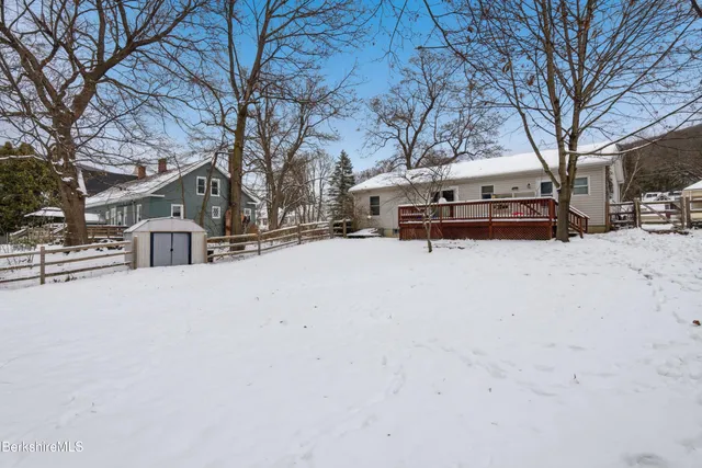 a wooden bench sitting in middle of a snow