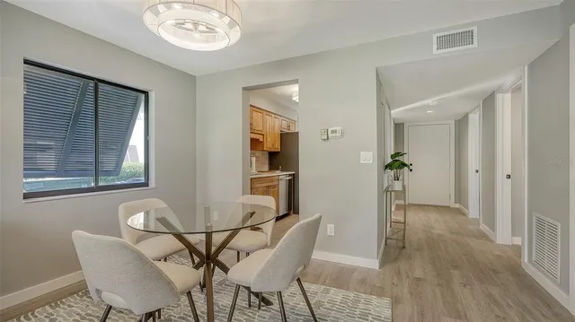 a view of a dining room with furniture and chandelier