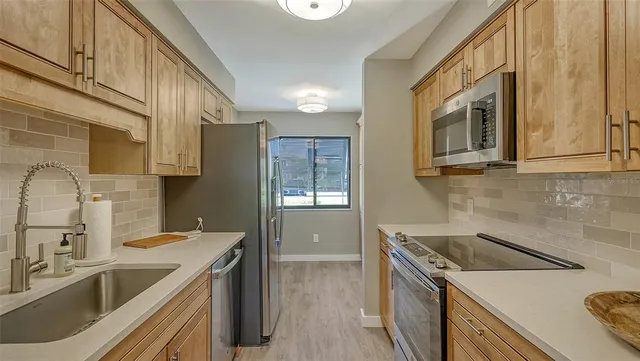 a kitchen that has a sink and a stove