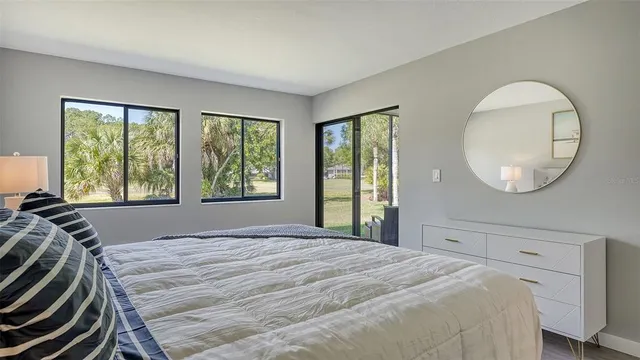 a bedroom with a large bed and a large window