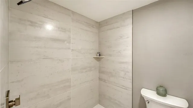 a bathroom with a toilet and shower