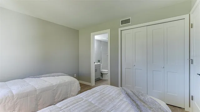 a bedroom with a bed and a bathroom