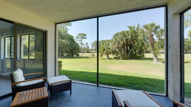 a view of a porch with furniture and garden
