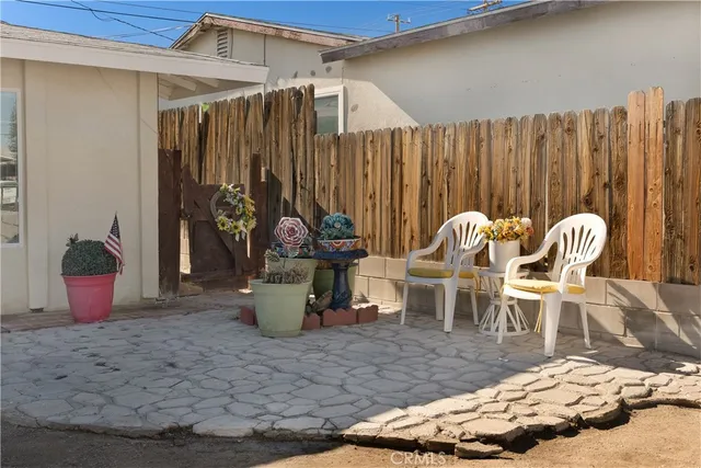 a view of a chairs and table in backyard