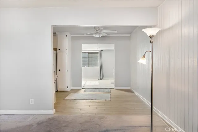 a view of a room with wooden floor and windows