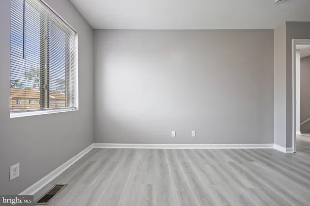 wooden floor and window in an empty room