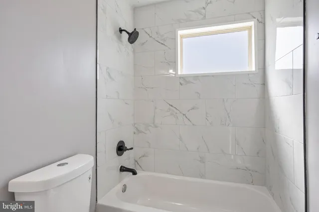 a bathroom with a bathtub and a toilet