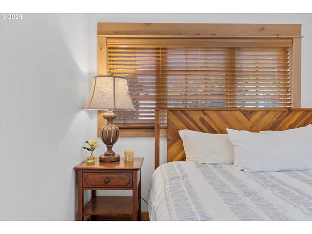 a bedroom with a bed and lamp