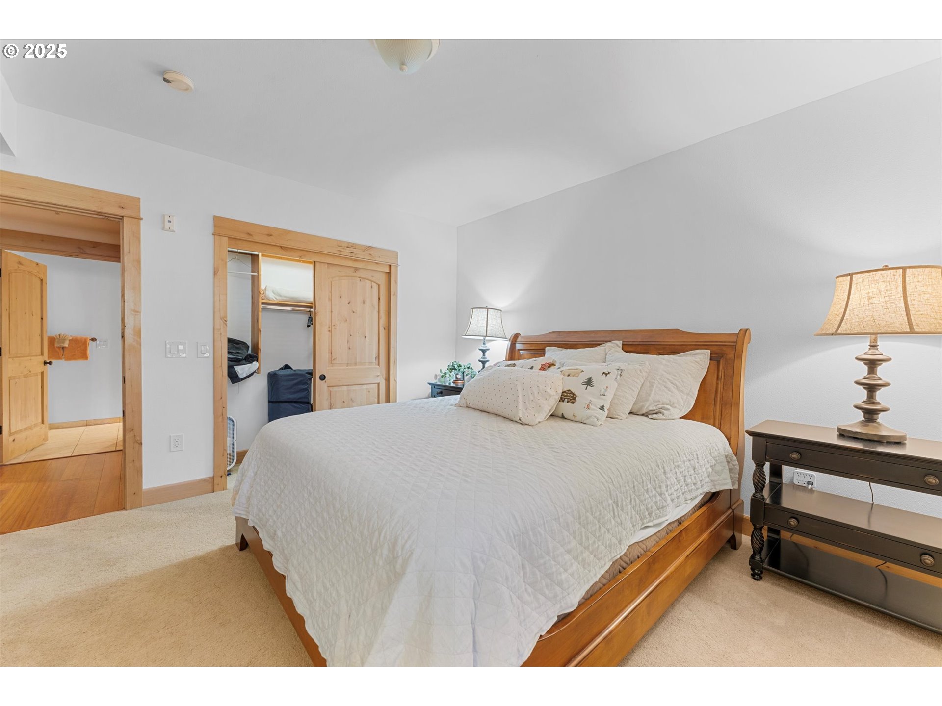 31200 East Collins Lake Road, Unit 1 Government Camp, OR 97028 - Photo 24 of 38 a bedroom with a bed and lamp