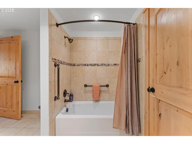 a bathroom with a shower and a sink