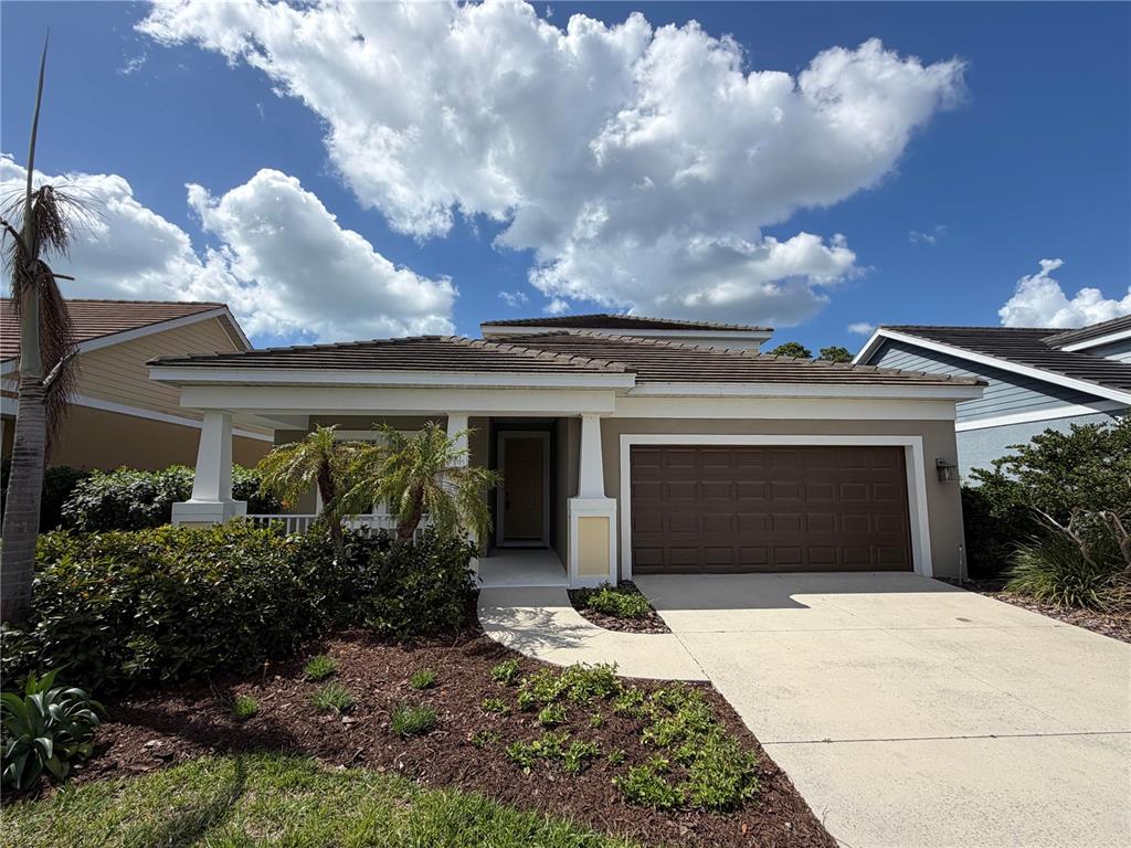 205 Cohosh Road Nokomis, FL 34275 - Photo 1 of 79 a front view of a house with a yard and a garage