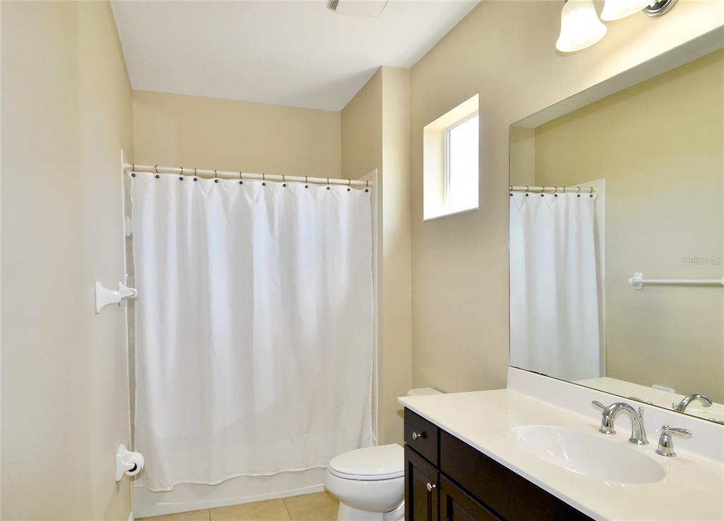205 Cohosh Road Nokomis, FL 34275 - Photo 15 of 79 a bathroom with a granite countertop sink toilet and a mirror