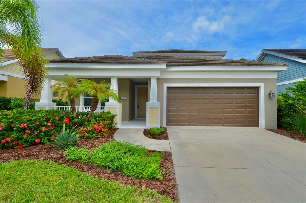 205 Cohosh Road Nokomis, FL 34275 - Photo 2 of 79 a front view of a house with a yard