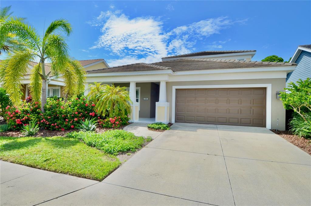 205 Cohosh Road Nokomis, FL 34275 - Photo 43 of 79 a front view of a house with a yard and garage