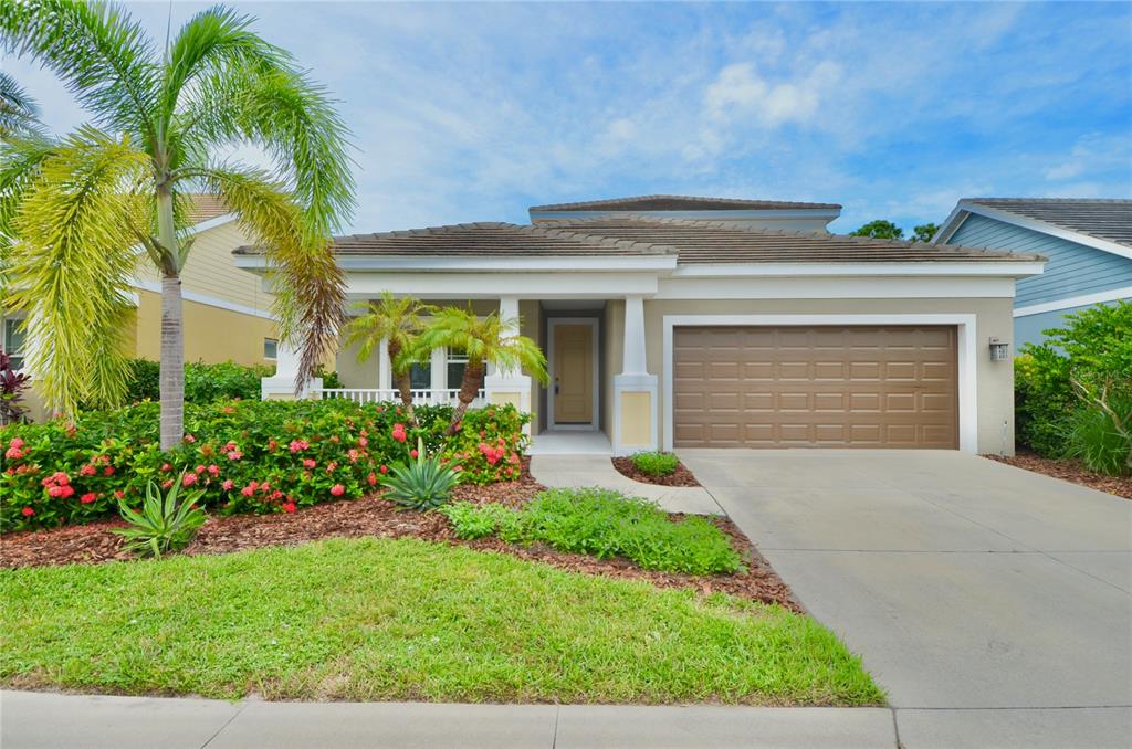 205 Cohosh Road Nokomis, FL 34275 - Photo 49 of 79 a front view of a house with a garden