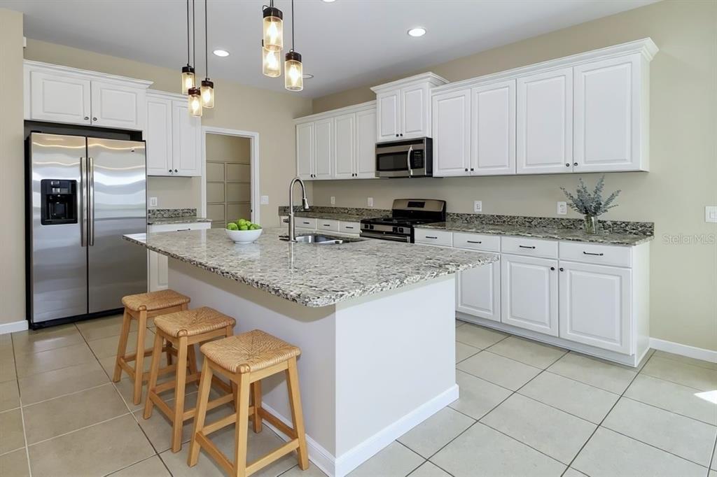 205 Cohosh Road Nokomis, FL 34275 - Photo 5 of 79 a kitchen with granite countertop a sink a counter top space appliances and cabinets