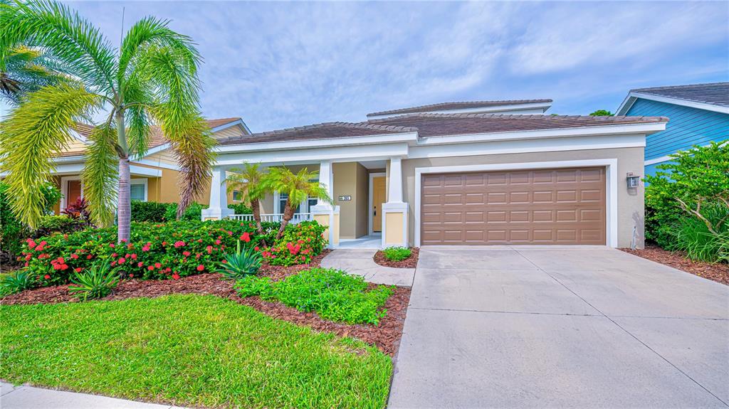 205 Cohosh Road Nokomis, FL 34275 - Photo 64 of 79 a front view of a house with a garden and plants