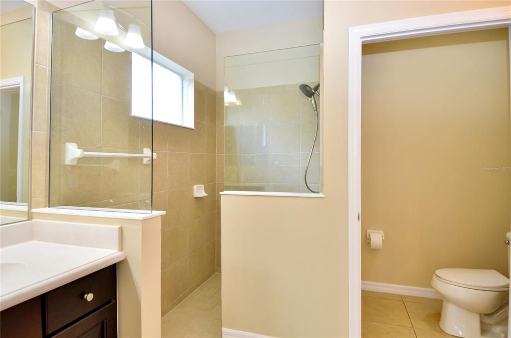 205 Cohosh Road Nokomis, FL 34275 - Photo 9 of 79 a bathroom with a granite countertop sink toilet and shower