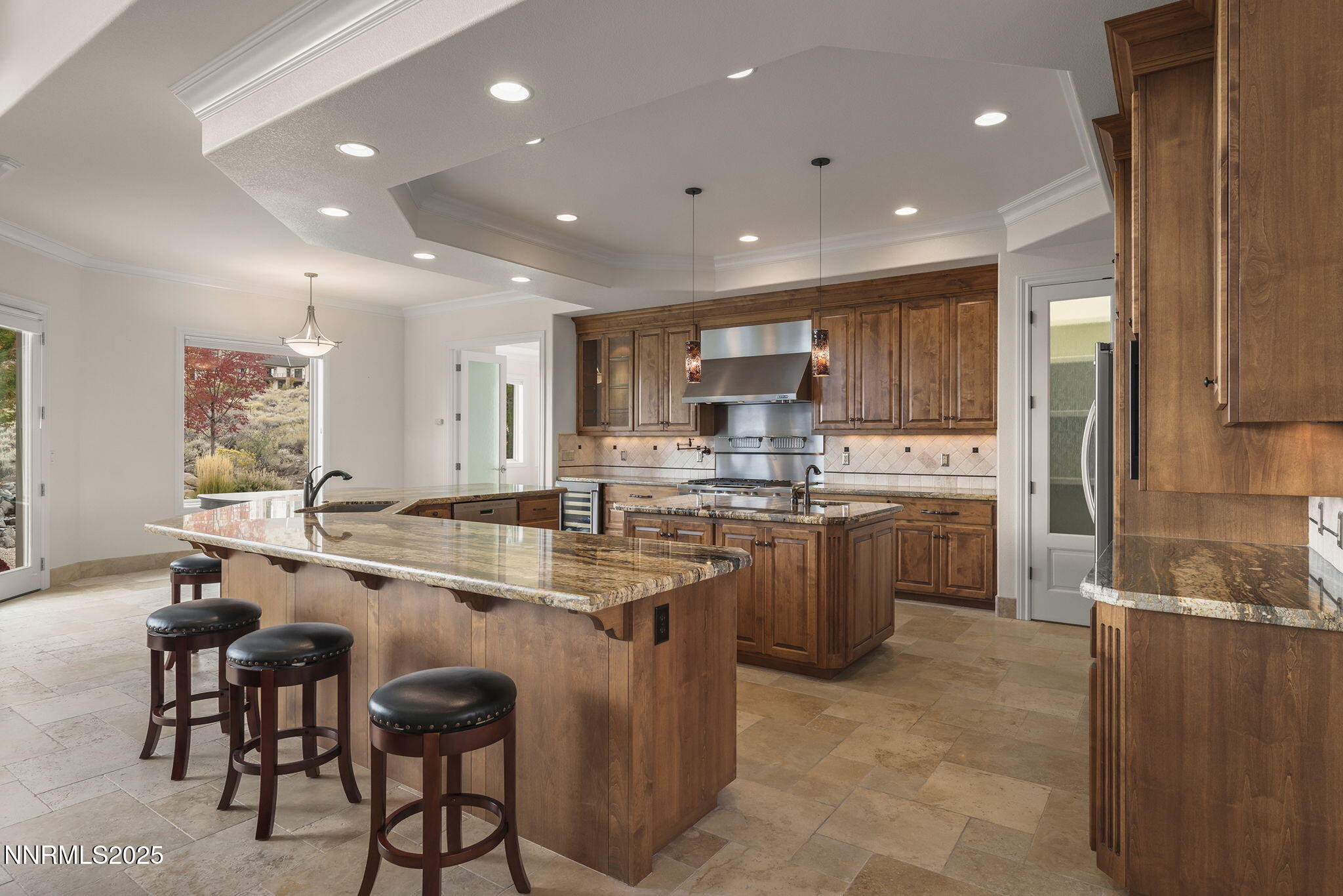 345 James Canyon Loop Genoa, NV 89411 - Photo 11 of 54 a kitchen with a sink window and stainless steel appliances