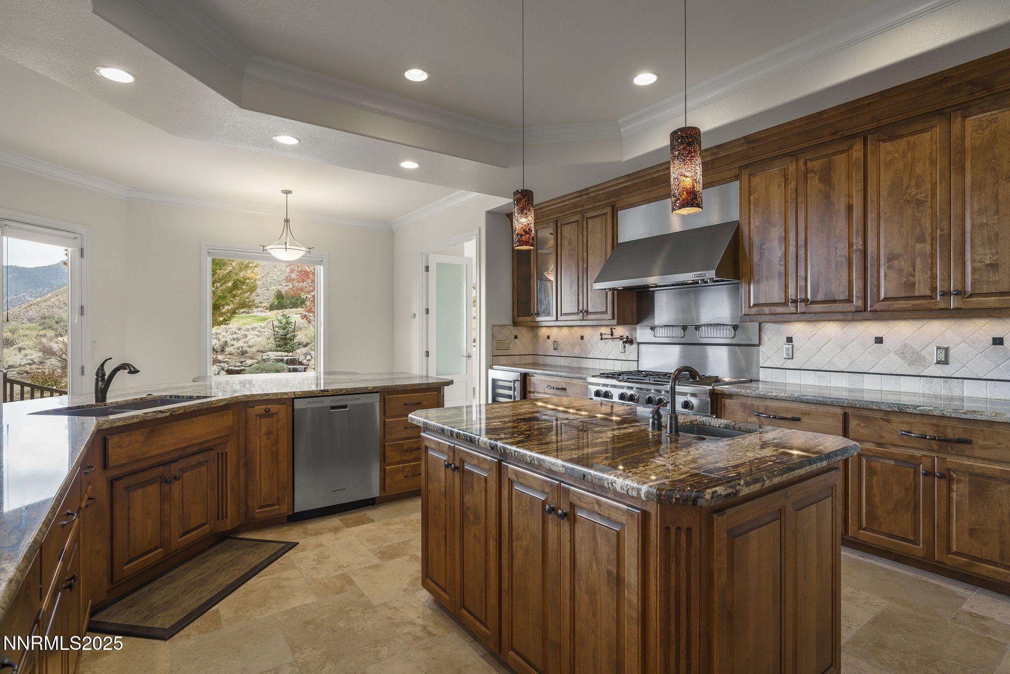 345 James Canyon Loop Genoa, NV 89411 - Photo 15 of 54 a kitchen with stainless steel appliances granite countertop a sink stove and cabinets