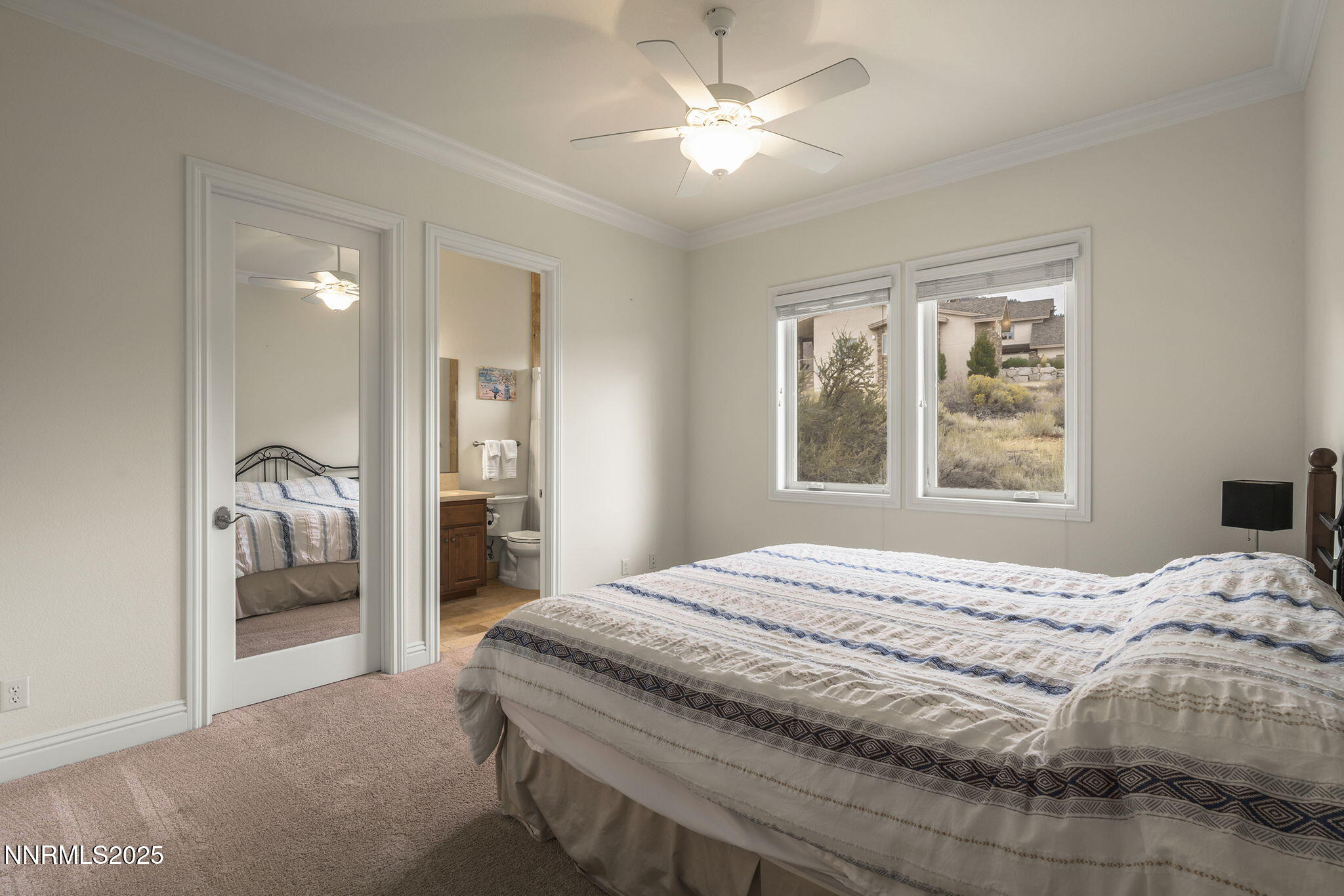 345 James Canyon Loop Genoa, NV 89411 - Photo 28 of 54 a bedroom with a bed next to a window