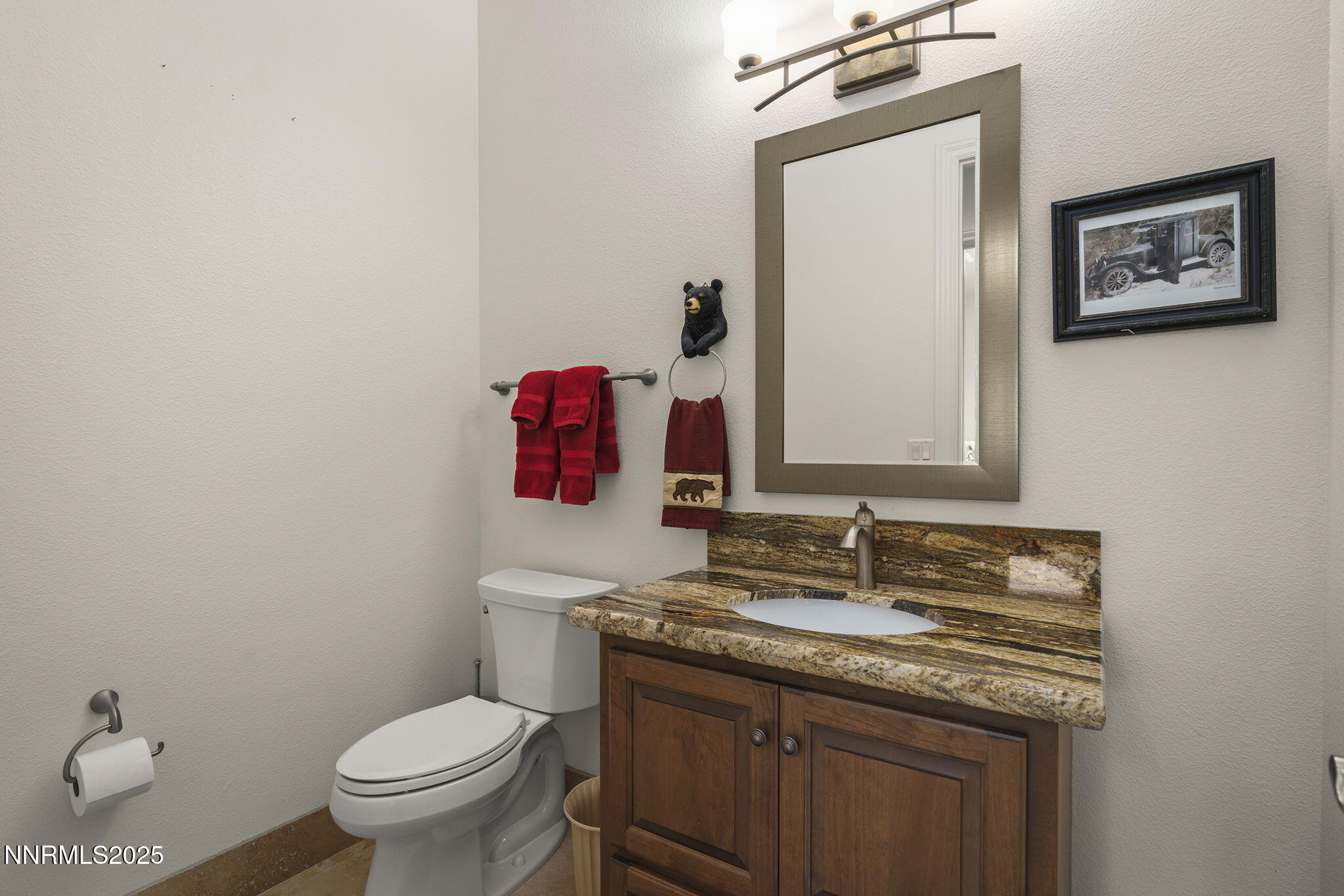 345 James Canyon Loop Genoa, NV 89411 - Photo 31 of 54 a bathroom with a granite countertop toilet sink and mirror