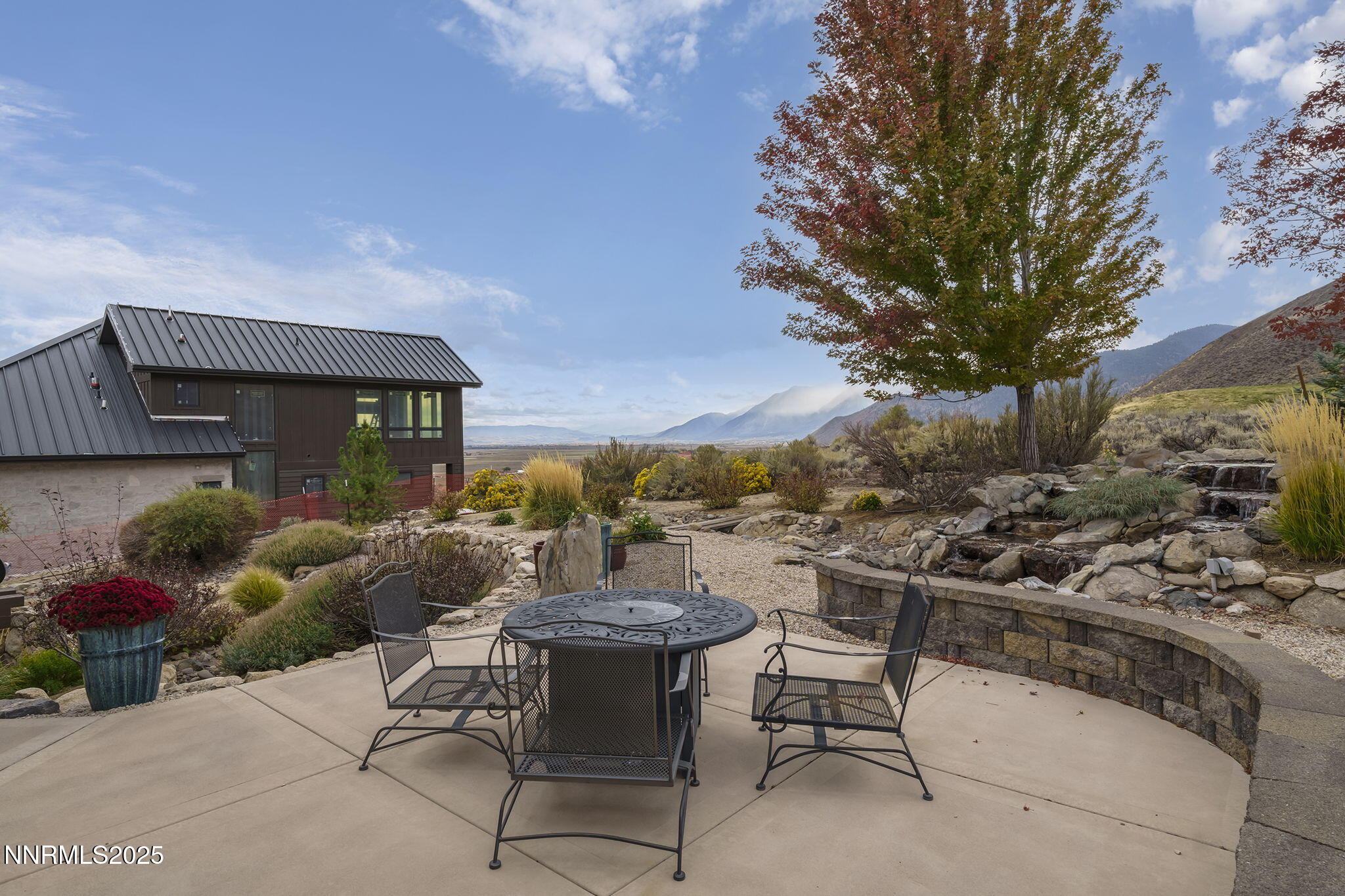 345 James Canyon Loop Genoa, NV 89411 - Photo 42 of 54 a view of a patio with couches table and chairs and potted plants