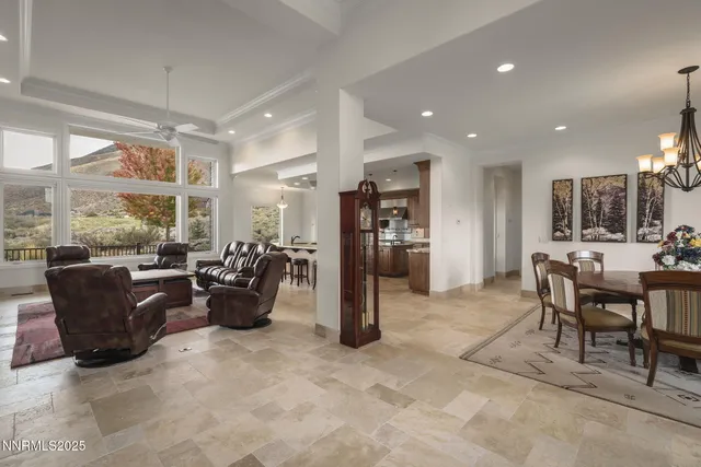 a living room with furniture a fireplace and a large window