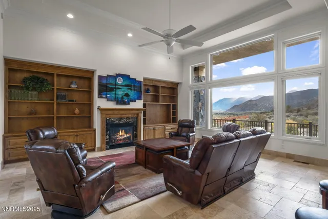 a living room with fireplace furniture and a large window
