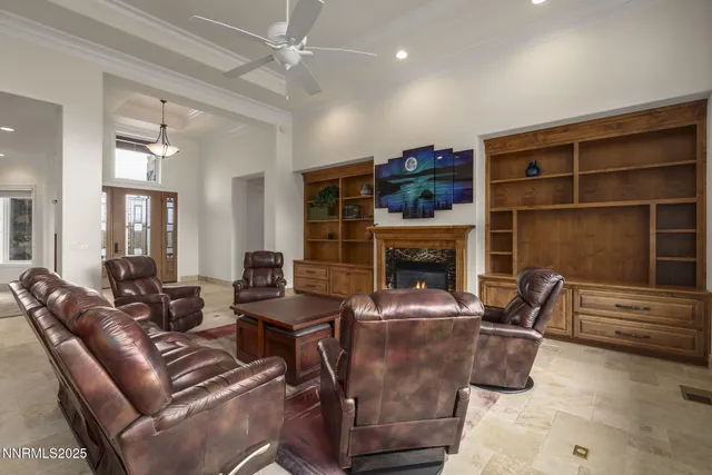 a living room with furniture kitchen view and a chandelier