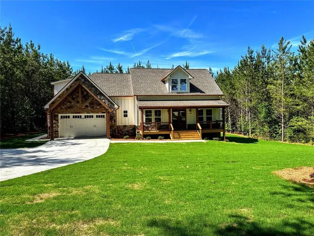 a front view of house with yard and green space