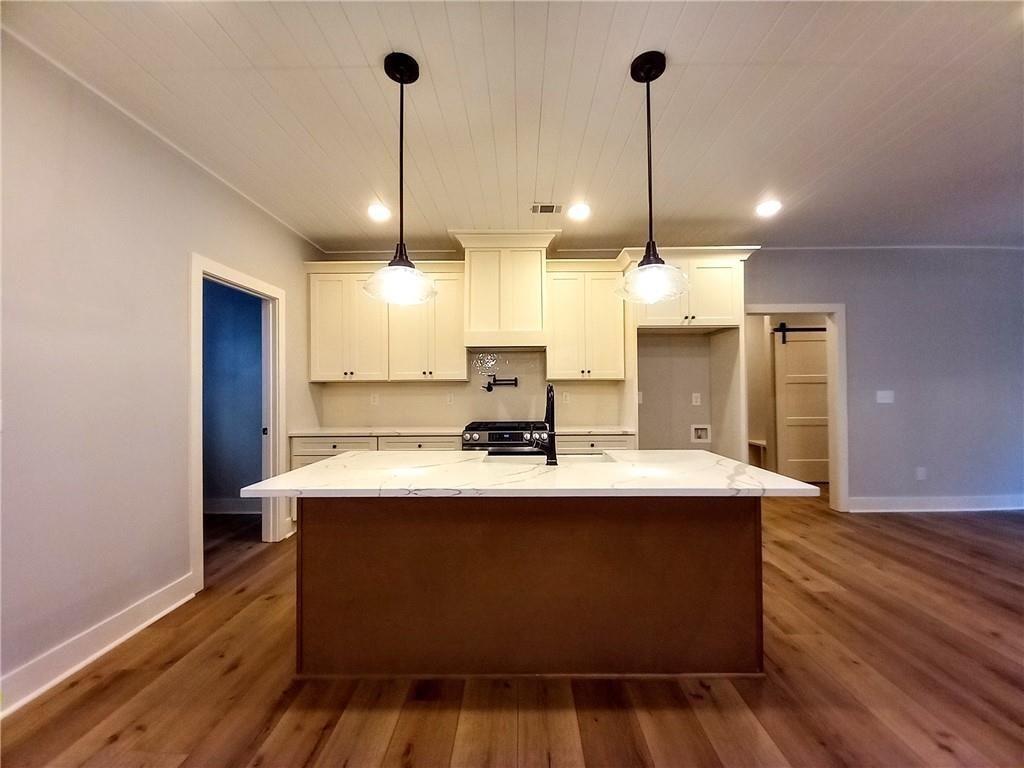136 Rainey Road Temple, GA 30179 - Photo 26 of 78 a view of a kitchen with kitchen island a sink stainless steel appliances and wooden floor