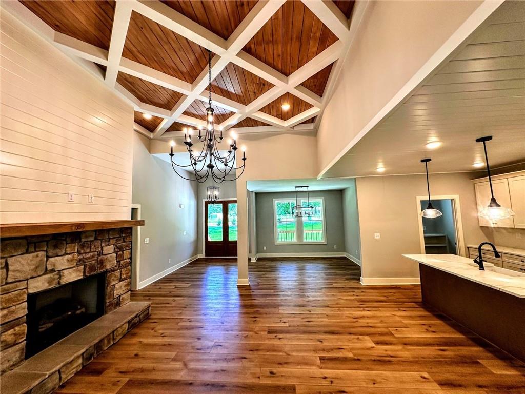 136 Rainey Road Temple, GA 30179 - Photo 29 of 78 a view of an empty room with wooden floor and a kitchen