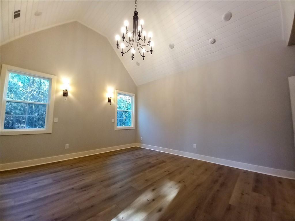 136 Rainey Road Temple, GA 30179 - Photo 46 of 78 a view of a chandelier in big room with wooden floor