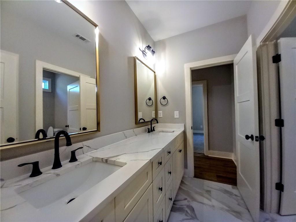 136 Rainey Road Temple, GA 30179 - Photo 64 of 78 a spacious bathroom with a double vanity sink a mirror and a shower