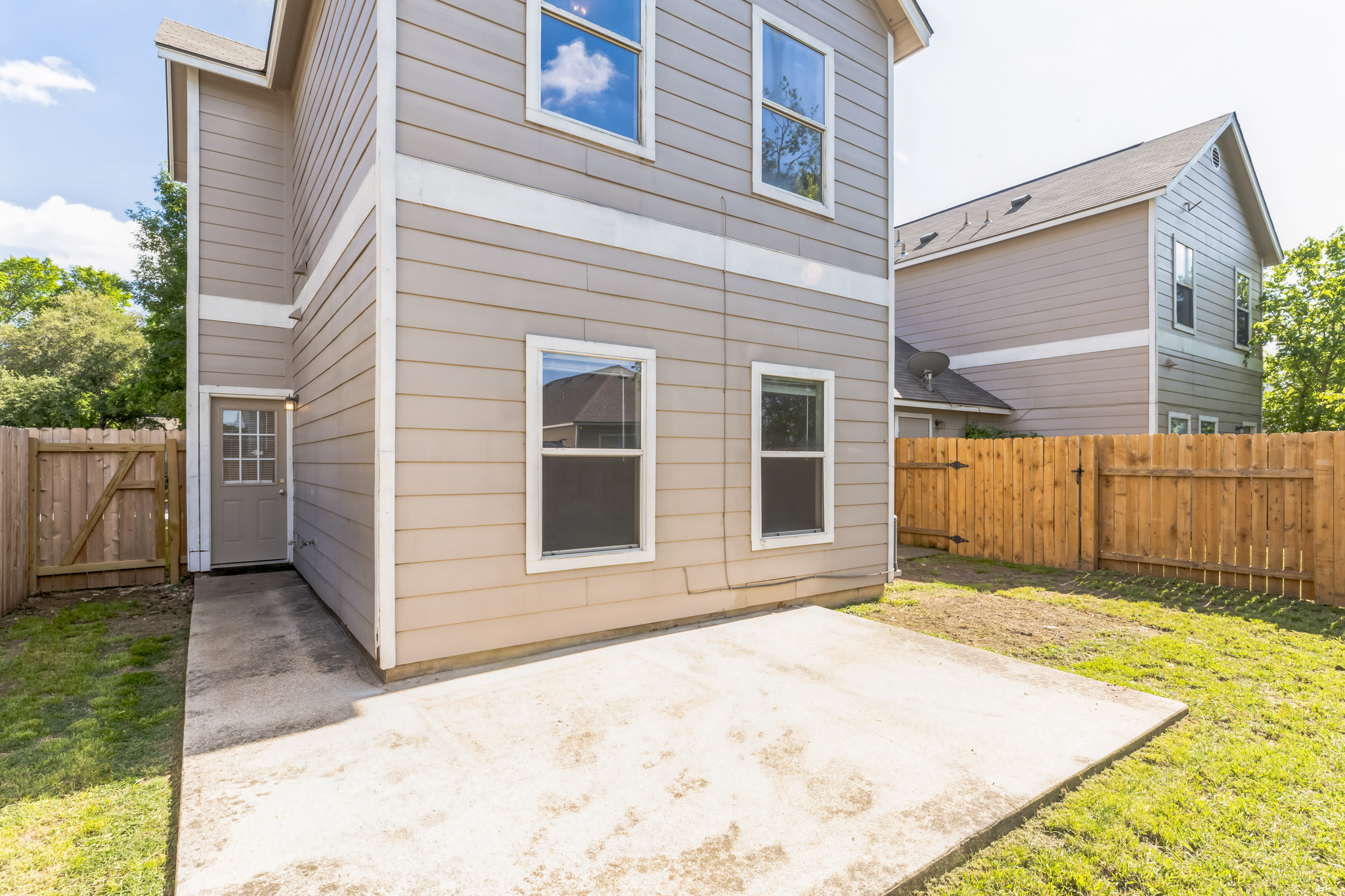 1107 East 3rd Street Georgetown, TX 78626 - Photo 11 of 36 Rear view of house featuring a gate, a fenced backyard, and a patio area