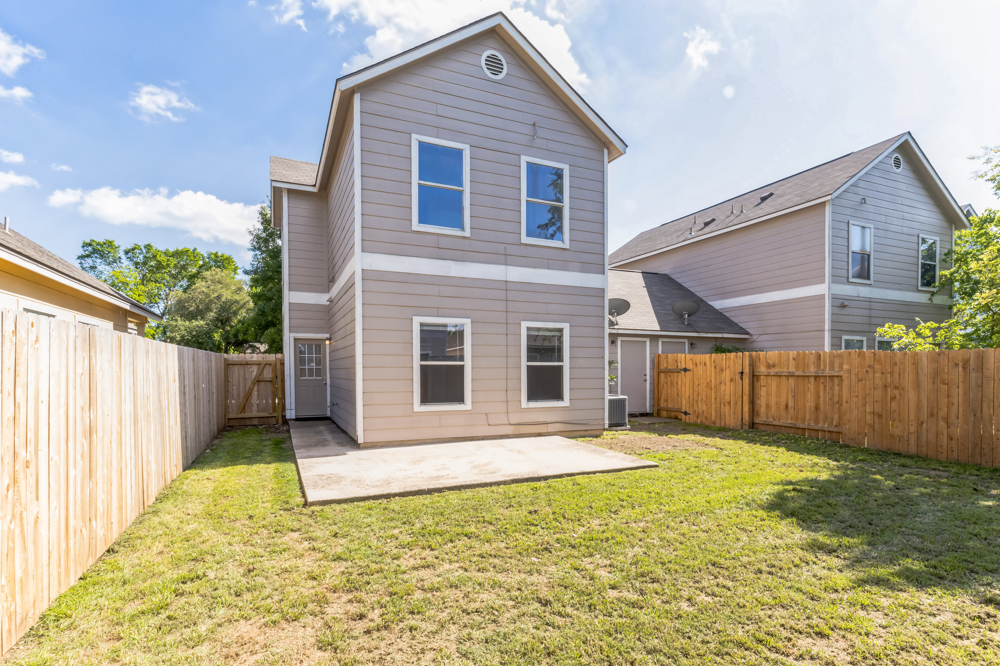 1107 East 3rd Street Georgetown, TX 78626 - Photo 12 of 36 Rear view of house featuring a patio area, a fenced backyard, and a gate