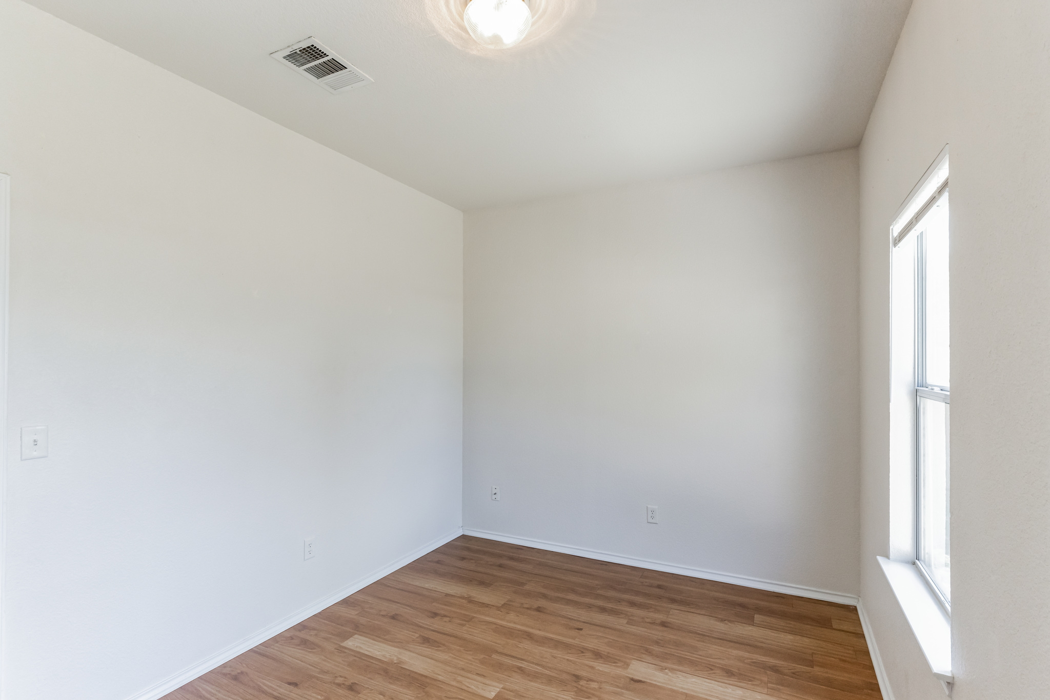 1107 East 3rd Street Georgetown, TX 78626 - Photo 15 of 36 Empty room featuring light wood-style floors and baseboards