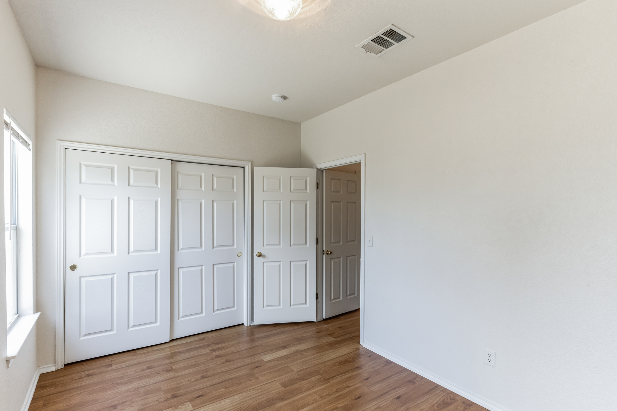 1107 East 3rd Street Georgetown, TX 78626 - Photo 16 of 36 Unfurnished bedroom with light wood finished floors and a closet
