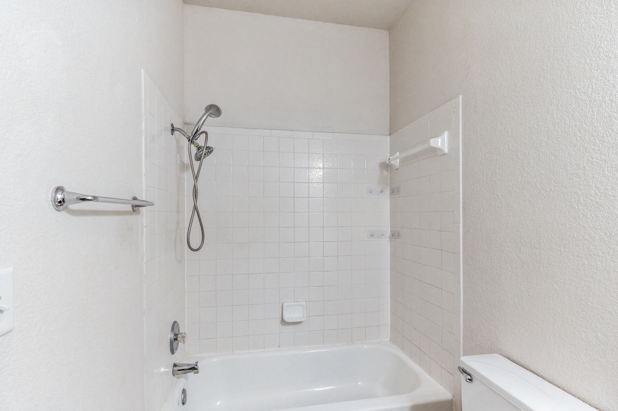 1107 East 3rd Street Georgetown, TX 78626 - Photo 23 of 36 Bathroom featuring shower / bath combination and a textured wall