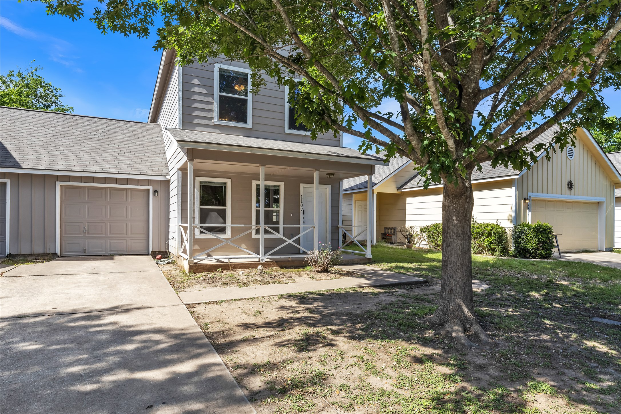 1107 East 3rd Street Georgetown, TX 78626 - Photo 33 of 36 Traditional home with roof with shingles, a porch, a garage, and concrete driveway