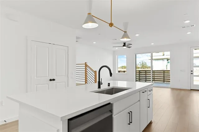 a kitchen with a sink a counter space and a window