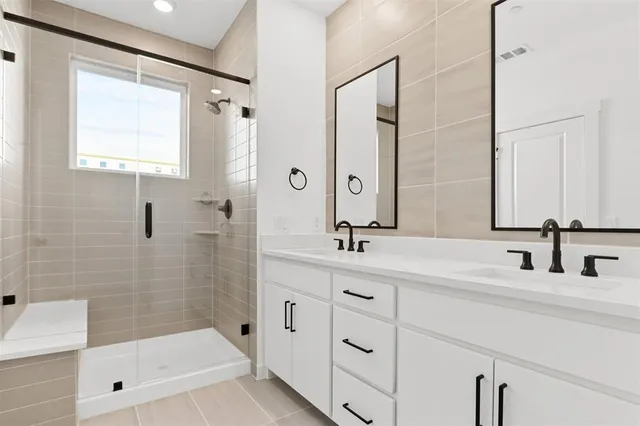 a bathroom with a tub sink and mirror